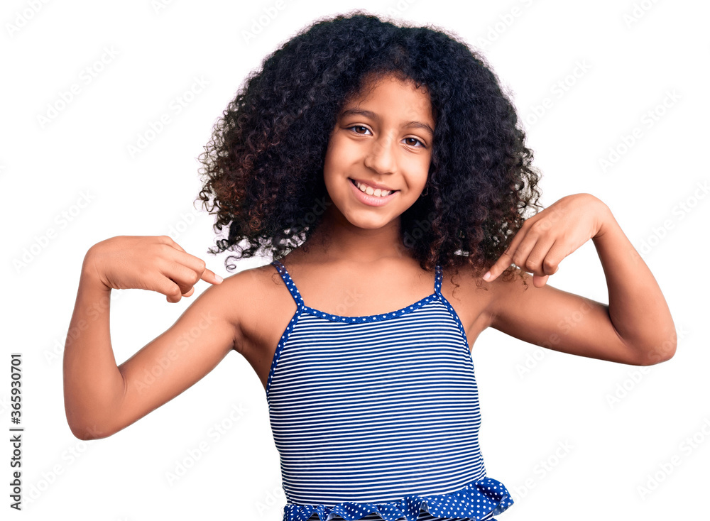 African american child with curly hair wearing swimwear looking confident with smile on face, pointing oneself with fingers proud and happy. African american child with curly hair wearing swimwear looking confident with smile on face, pointing oneself with fingers proud and happy.