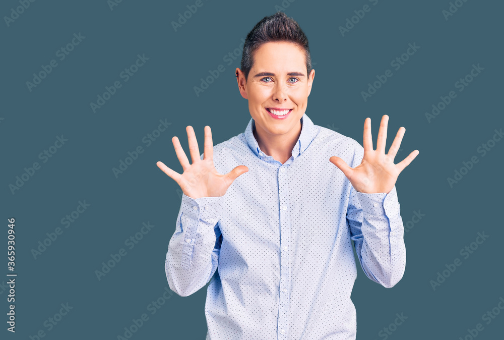Young woman with short hair wearing business clothes showing and pointing up with fingers number ten while smiling confident and happy. Young woman with short hair wearing business clothes showing and pointing up with fingers number ten while smiling confident and happy.