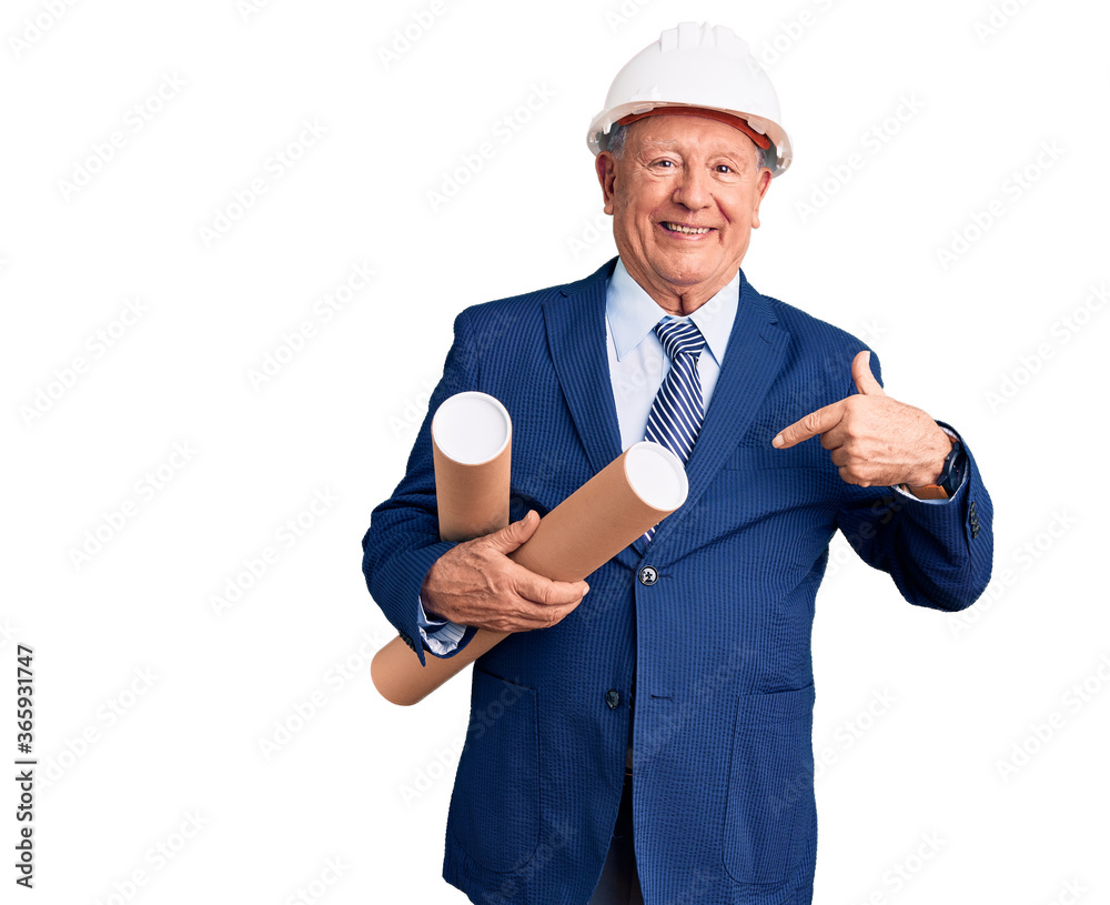 Senior handsome grey-haired man wearing architect hardhat holding blueprints pointing finger to one self smiling happy and proud