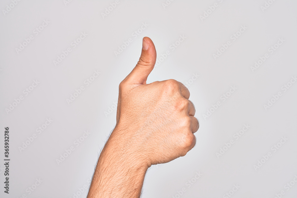 Hand of caucasian young man showing fingers over isolated white background doing successful approval gesture with thumbs up, validation and positive symbol