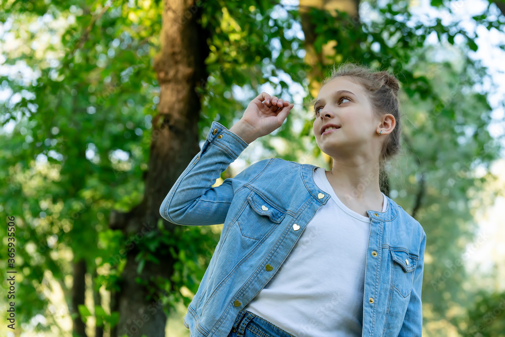 Girl in blue denim clothes posing in the park. Girl in blue denim clothes posing in the park.