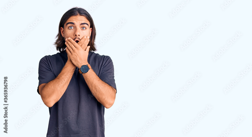 Young handsome man wearing casual clothes shocked covering mouth with hands for mistake. secret concept. Young handsome man wearing casual clothes shocked covering mouth with hands for mistake. secret concept.