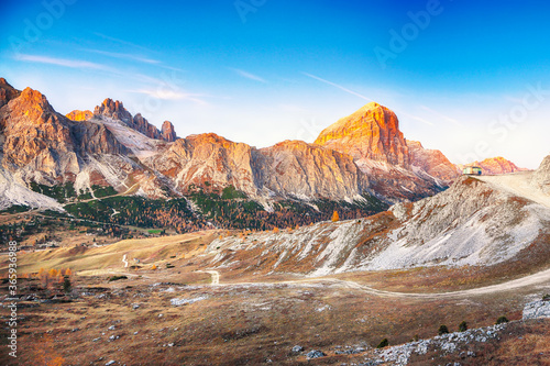 Picturesque autumn landscape with yellow larches and spectacular mountain ranges Lagazuoi and Tofana