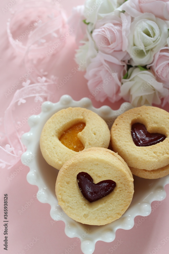 Heart shaped Jam cookie on pink background with copy space