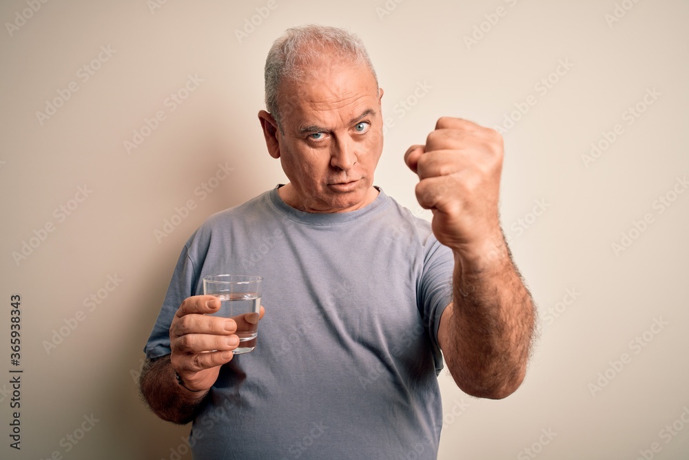 Middle age handsome hoary man drinking glass of water over isolated white background annoyed and frustrated shouting with anger, crazy and yelling with raised hand, anger concept Middle age handsome hoary man drinking glass of water over isolated white background annoyed and frustrated shouting with anger, crazy and yelling with raised hand, anger concept