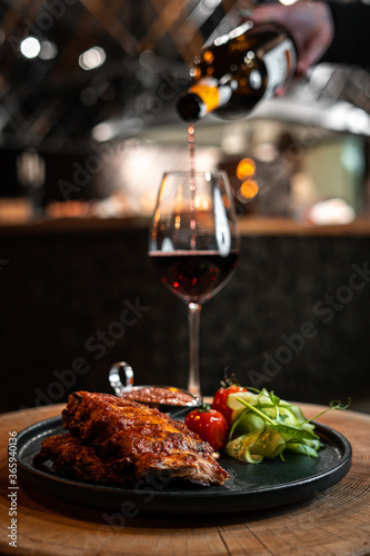 Restaurant dinner with meat and vegetables and wine