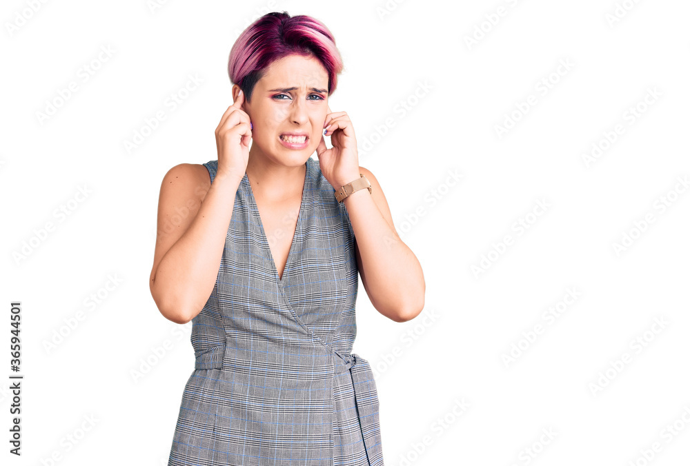 Young beautiful woman with pink hair wearing casual clothes covering ears with fingers with annoyed expression for the noise of loud music. deaf concept. Young beautiful woman with pink hair wearing casual clothes covering ears with fingers with annoyed expression for the noise of loud music. deaf concept.