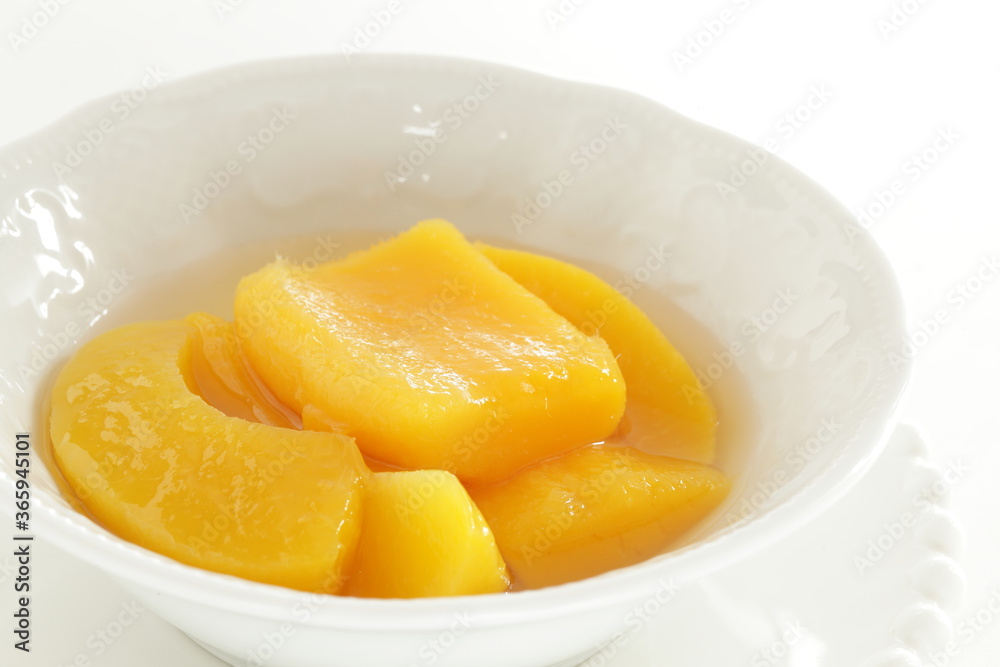 Canned food, mango and syrup in white bowl Canned food, mango and syrup in white bowl