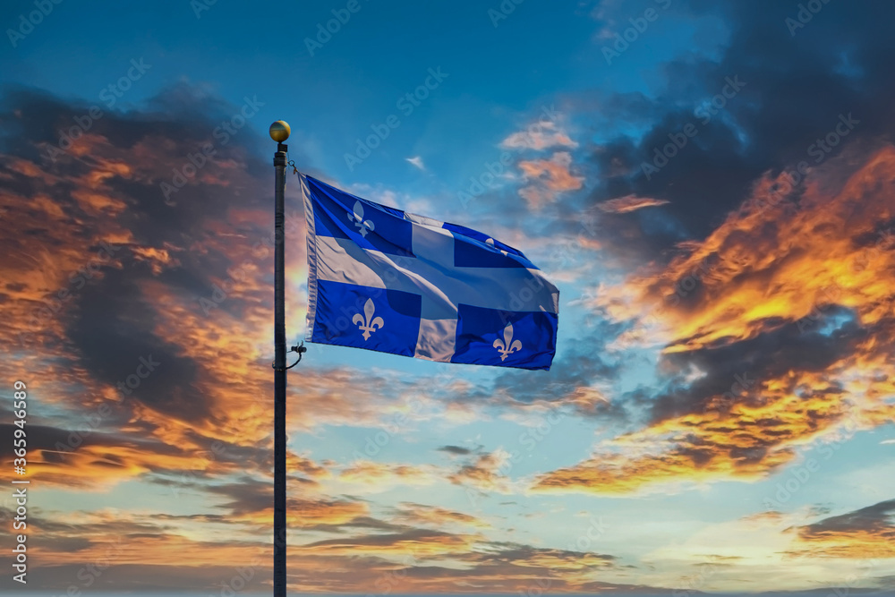 Naklejka premium Flaga Quebecu lecąca na tle nieba