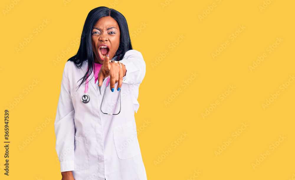 Young african american woman wearing doctor stethoscope pointing displeased and frustrated to the camera, angry and furious with you Young african american woman wearing doctor stethoscope pointing displeased and frustrated to the camera, angry and furious with you