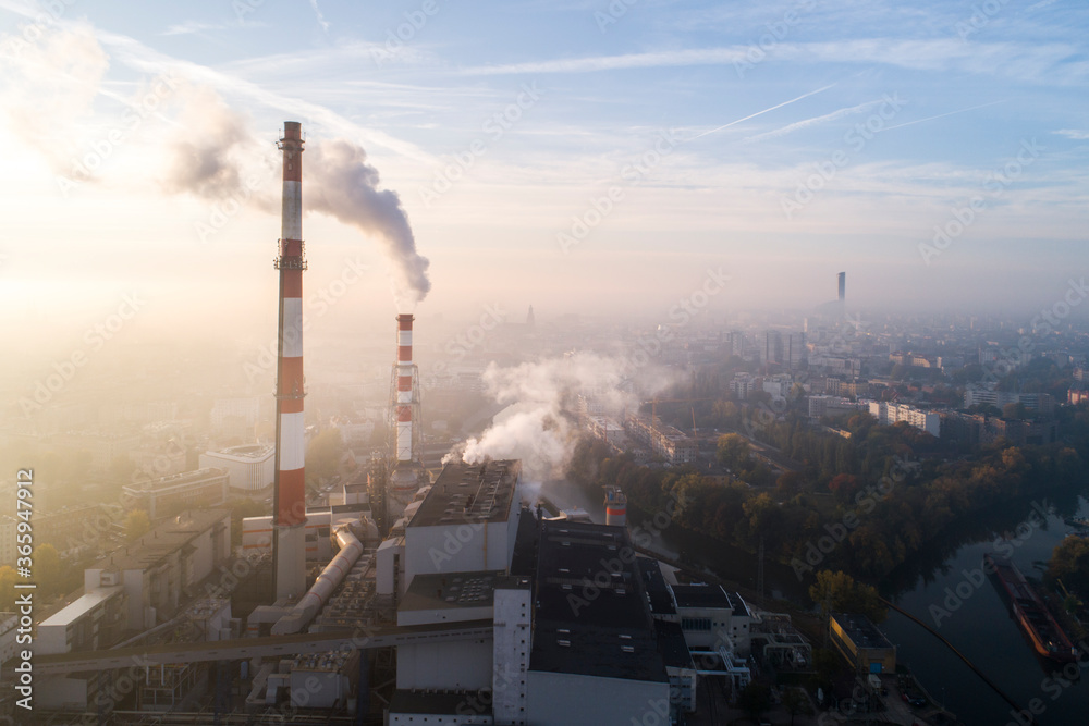 Air pollution in the city. Aerial view of the smog over the city in the morning, smoking chimneys of the CHP plant and the city's buildings - Wroclaw, Poland
