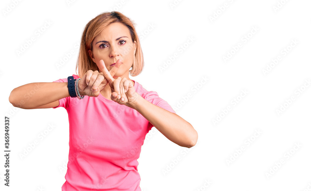 Young blonde woman wearing sportswear rejection expression crossing fingers  doing negative sign Stock Photo | Adobe Stock