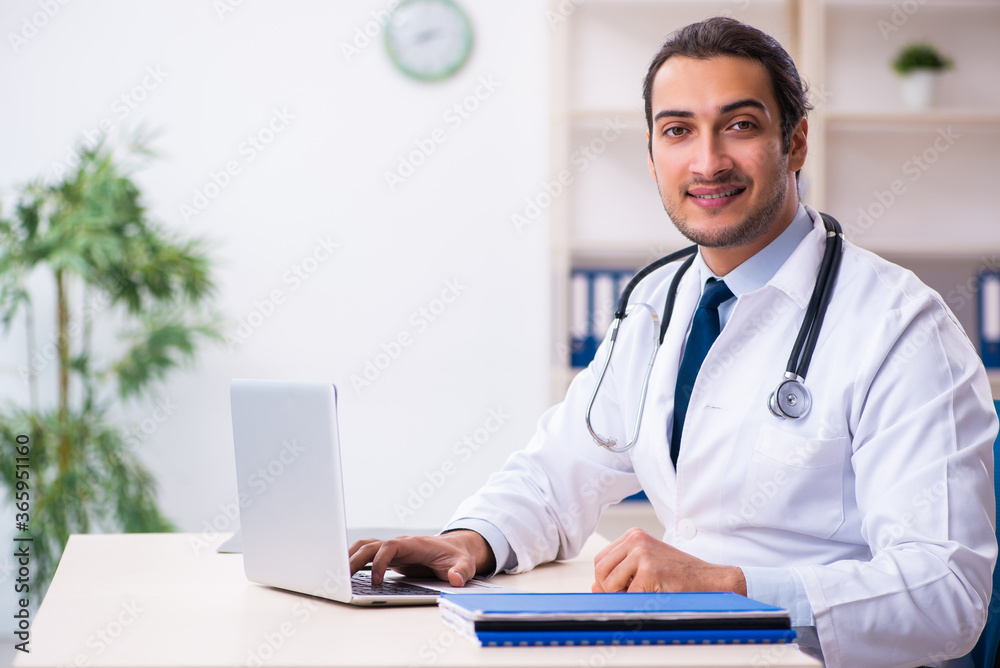Young male handsome doctor working in the clinic Young male handsome doctor working in the clinic