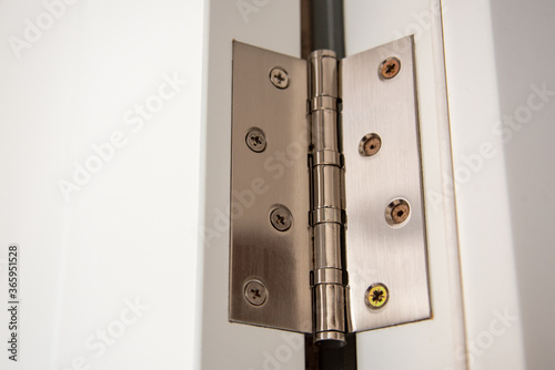 door hinges Aluminum on white door close up