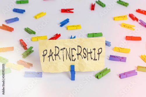 Handwriting text writing Partnership. Conceptual photo business type in which two or more individuals share ownership Colored clothespin papers empty reminder white floor background office photo