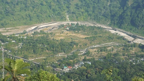 Footage of Joldhaka river flowing through India Bhutan international border at Jhalong, Dooars - West Bengal , India. River dividing two countries. Shot from Indian side. photo