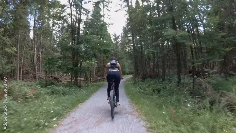 Rear view of woman riding a bike Rear view of woman riding a bike