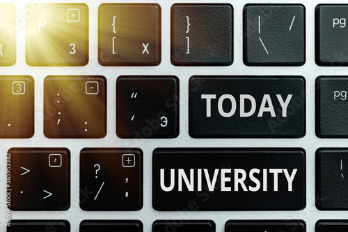 Handwriting text University. Conceptual photo an educational institution designed to teach and investigate Pc keyboard key with empty note paper above background copy space photo