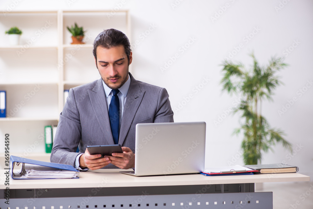 Young businessman employee sitting in the office Young businessman employee sitting in the office
