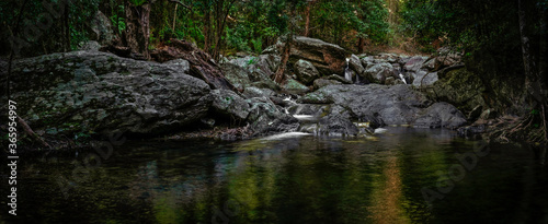 A magic time in the rainforest. Several small falls dropping from mossy rocks.  The Stoney Creek, Kamerunga, Cairns, Far North Queensland, Australia.  photo