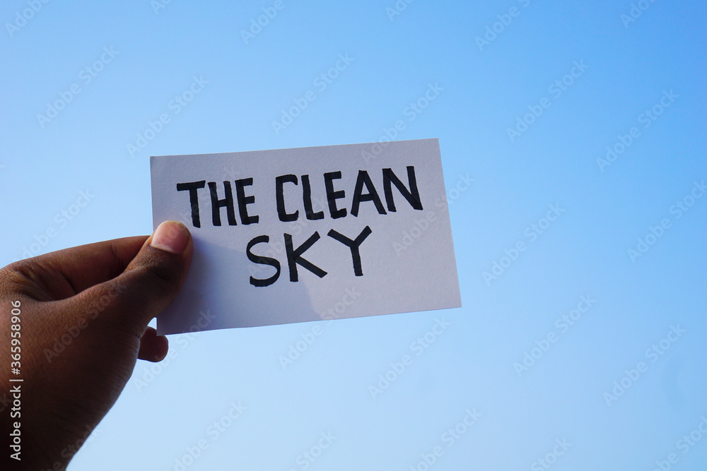 Hand holding paper text the clean sky with clean sky background Hand holding paper text the clean sky with clean sky background