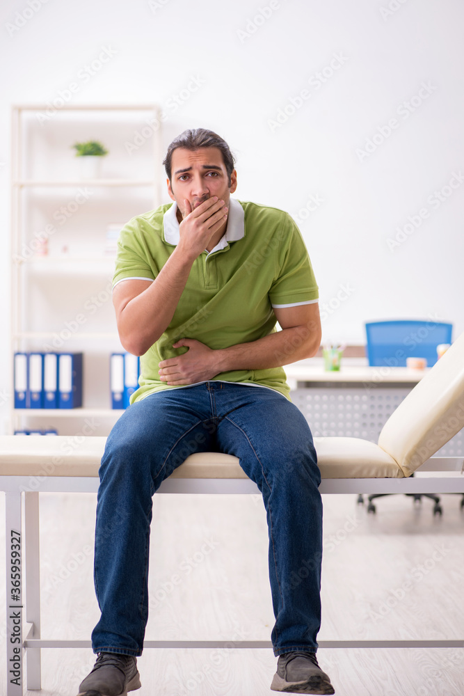 Young male patient waiting for doctor in the hospital