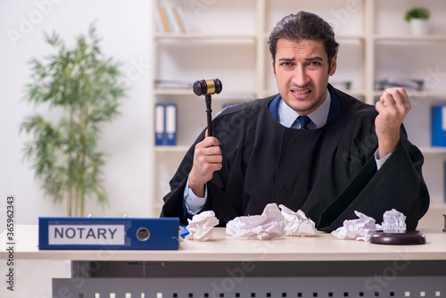 Young male judge working in courthouse photo