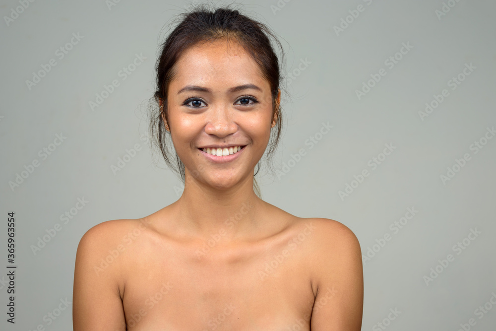 Obraz premium Happy young beautiful Asian woman shirtless as health and beauty concept