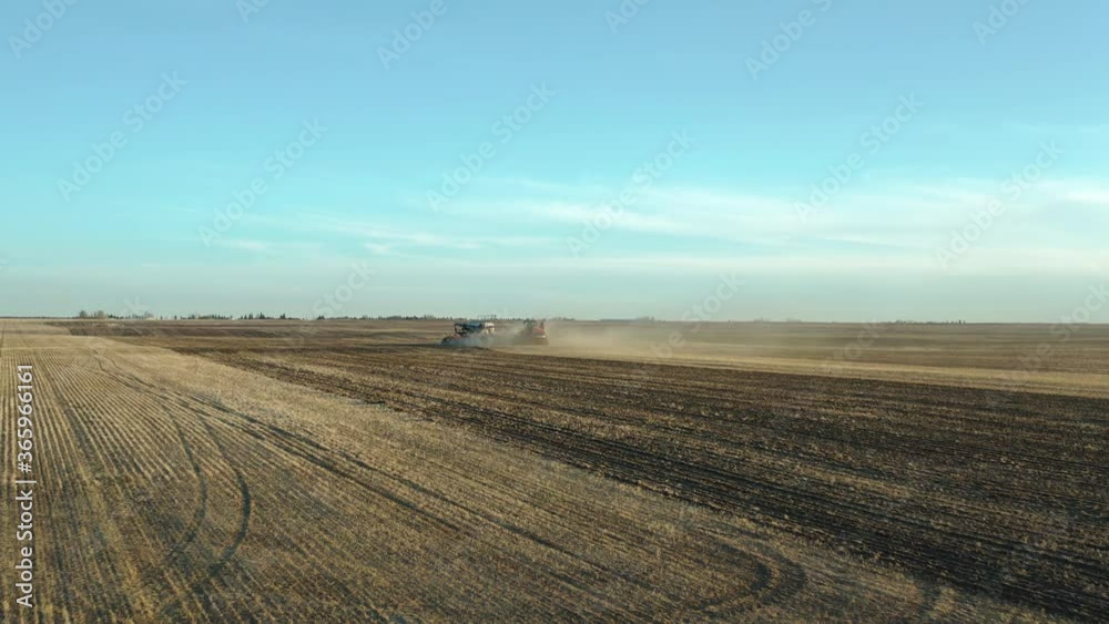 Farm Seeding In Saskatchewan, Canada With Blue Summer Sky Background - Wide Shot (Forward) Farm Seeding In Saskatchewan, Canada With Blue Summer Sky Background - Wide Shot (Forward)