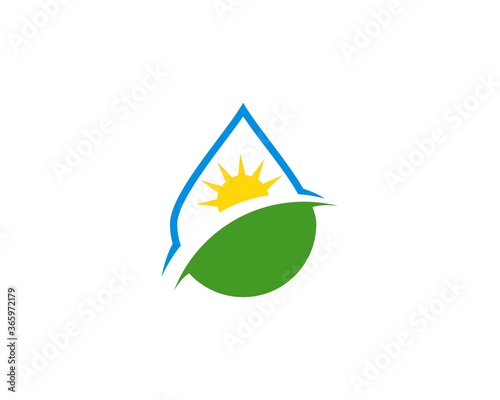 Water drop with green field and sun inside