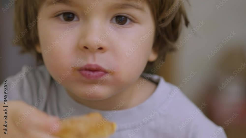 Cute Little Caucasian Boy Eating Pizza. Hungry Child Bites Pizza. Small Child in a Fast Food Cafe Eats. Close Up Portrait of a Kid Eating Lunch. Face Young Little Boy Closeup.Time Lapse. Cute Little Caucasian Boy Eating Pizza. Hungry Child Bites Pizza. Small Child in a Fast Food Cafe Eats. Close Up Portrait of a Kid Eating Lunch. Face Young Little Boy Closeup.Time Lapse.
