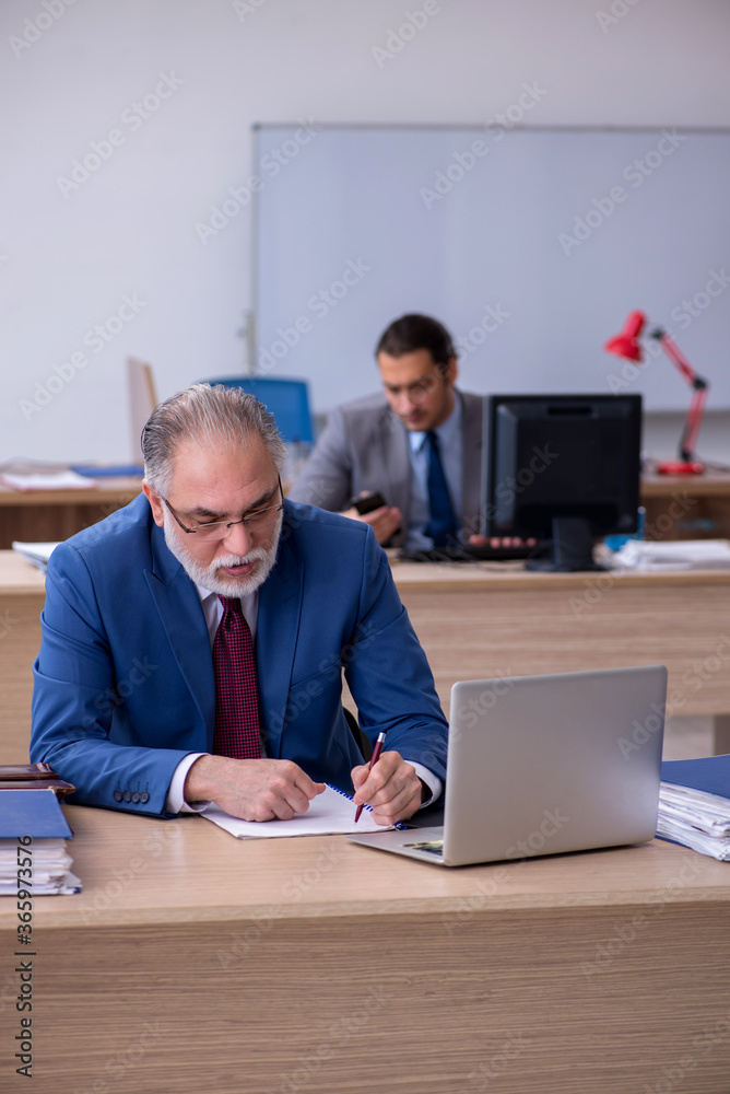 Two male employees working in the office Two male employees working in the office