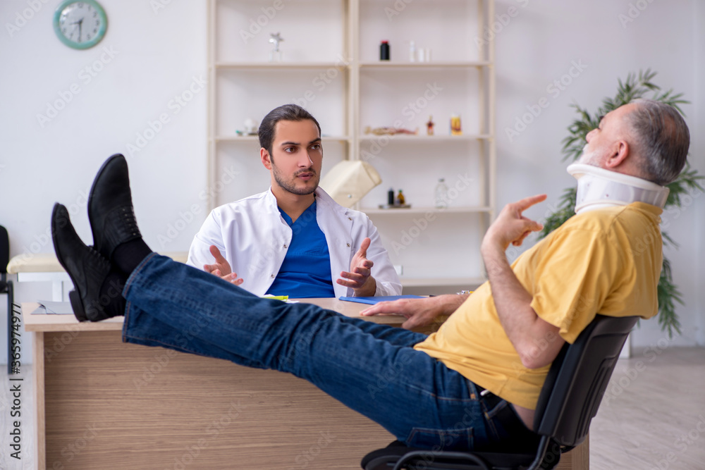 Old neck injured man visiting young male doctor Old neck injured man visiting young male doctor