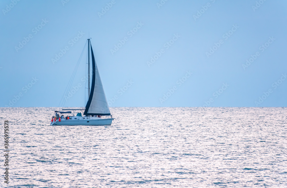 Fototapeta premium Sailing yacht in the blue calm sea.