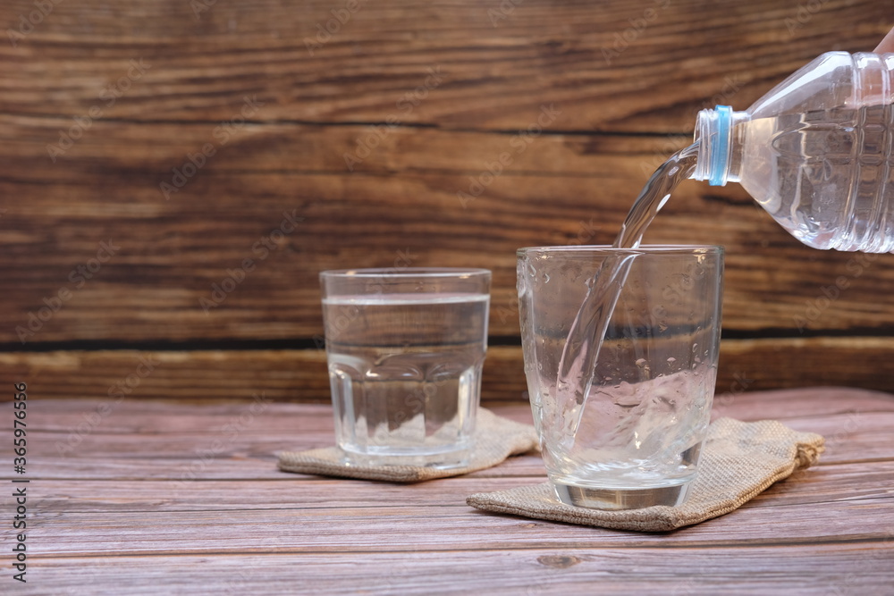 glass of water on wooden table glass of water on wooden table