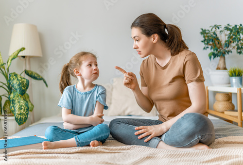 mother is scolding her child girl.