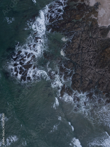 Aerial photo of small waves breaking. Taken off the coast of a small surf town in beautiful New Zealand. 
