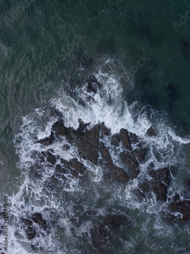 Aerial photo of small waves breaking. Taken off the coast of a small surf town in beautiful New Zealand. 