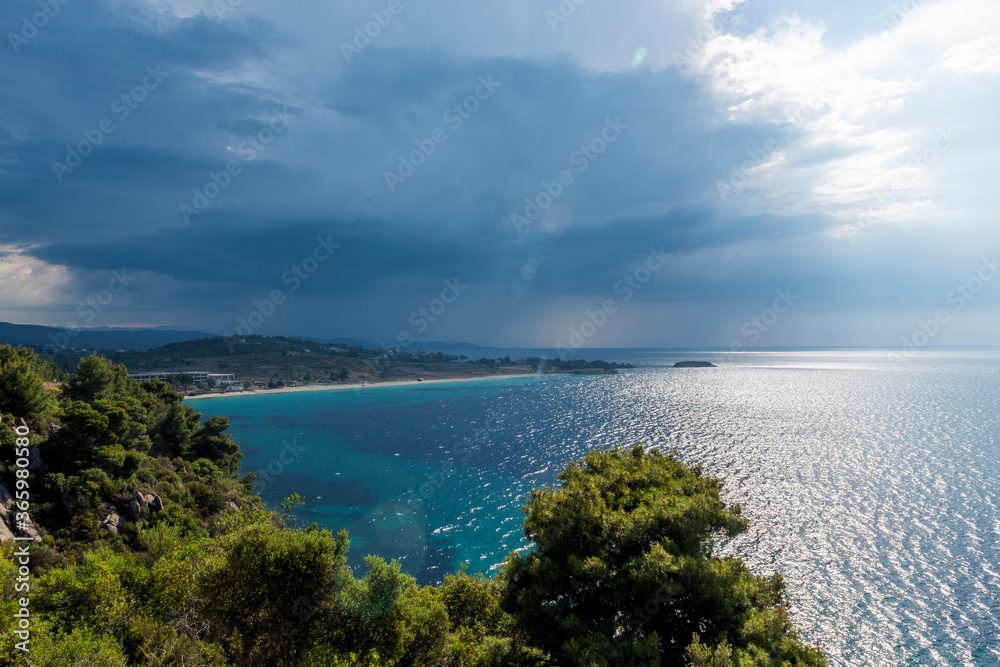 Landscape with beach, the sea and the clouds in the blue sky