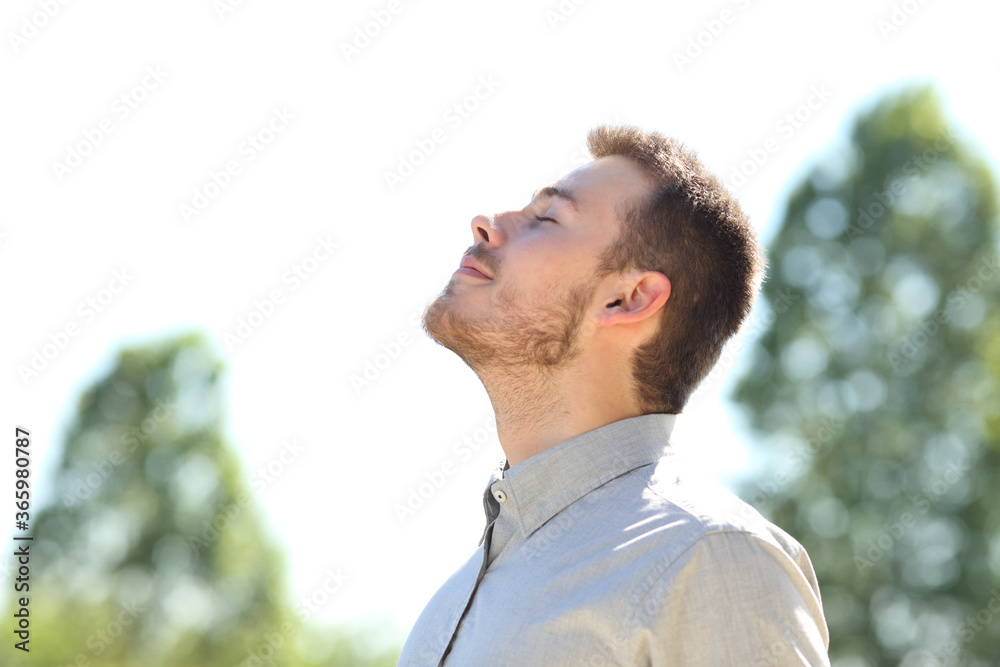Man breathing fresh air standing outdoors Man breathing fresh air standing outdoors