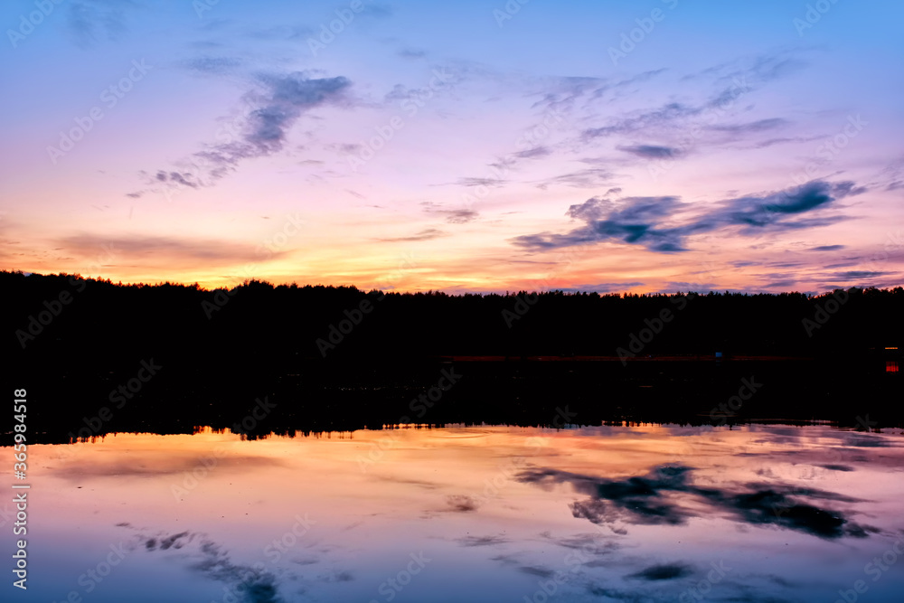 summer sunset sky landscape in forest park with rural scenery reflection on pond water. Natural color of summer evening nature. Dusk in park. Wide view