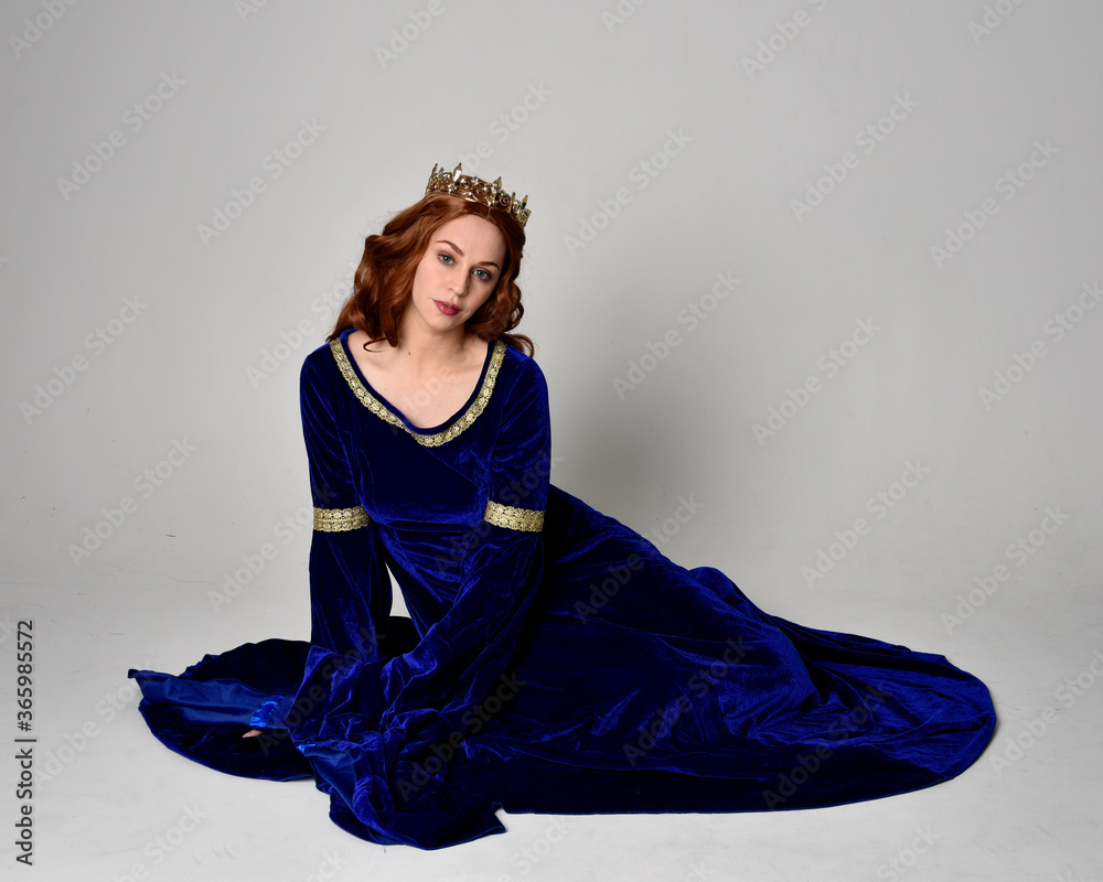 Full length portrait of girl wearing long blue velvet gown with golden ...