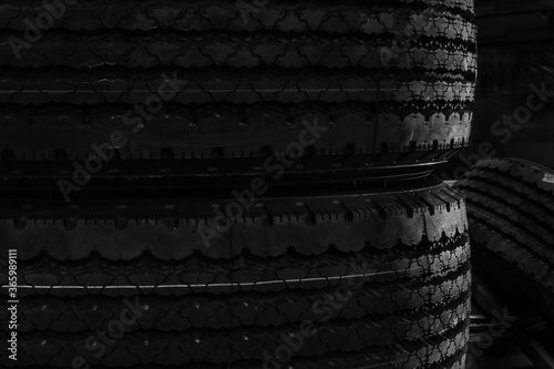 Set of new tires on black background with contrasty lighting. Close up product photograph of unused tyres