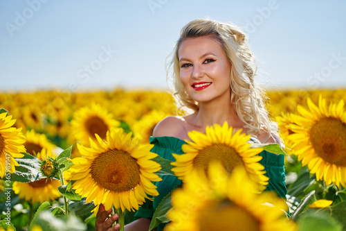 Young beautiful woman in a sunflower field