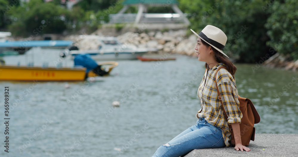 Travel woman sits on the pier Travel woman sits on the pier