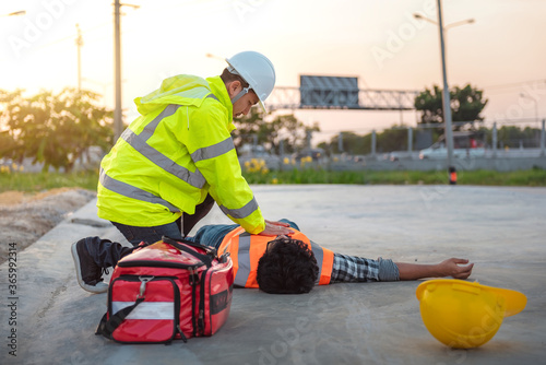 Accident at work of construction labor people, Basic First aid and CPR Training at outdoor. Heat Stroke or Heat exhaustion in body concept. photo