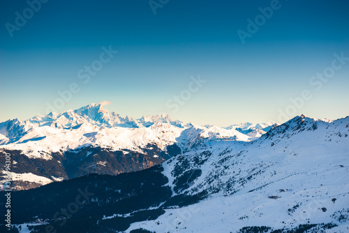 Ski resort in winter mountains. Panoramic view of Mont Blanc mountain ridge. Meribal  3 Valleys  France. Beautiful winter landscape of mountains at sunset