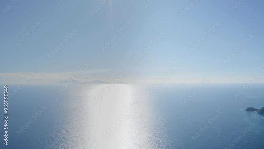 Aerial panoramic shot of azure sea. On the horizon is a mountain shadow (Antigua and Barbuda) Aerial panoramic shot of azure sea. On the horizon is a mountain shadow (Antigua and Barbuda)