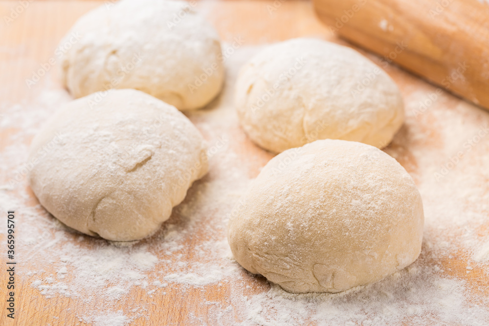 Freshly prepared yeast dough for pizza or bread on wooden background. Freshly prepared yeast dough for pizza or bread on wooden background.