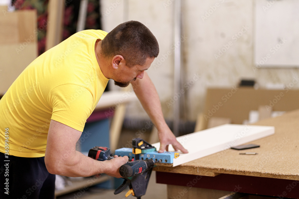 Carpenter working on wood craft at workshop to produce wooden furniture. Caucasian carpenter use professional tools for crafting. DIY maker and carpentry work concept. Carpenter working on wood craft at workshop to produce wooden furniture. Caucasian carpenter use professional tools for crafting. DIY maker and carpentry work concept.